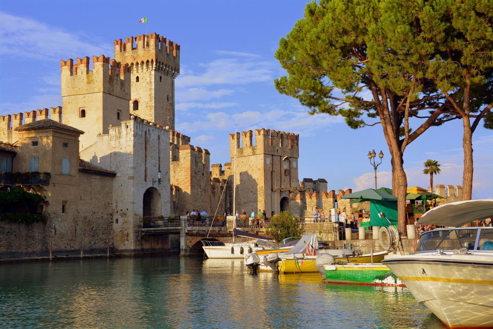 Sirmione: Walking and Speedboat Tour - Entering the historic center through a bridge